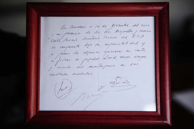 In this photo taken, Thursday, Jan. 5, 2012,  a framed copy of the napkin linking a 13-year-old Lionel Messi to FC Barcelona is seen in Barcelona, Spain. The club's technical secretary and past coach Carles Rexach scribbled out an informal contract on a napkin, the closest piece of paper he could find at Barcelona's Pompei Tennis Club. The small napkin reads: "In Barcelona, on the 14th of December of 2000 and in the presence of Josep Minguella and Horacio (Gaggioli), Carles Rexach, F.C.B technical secretary, it commits under his responsibility and despite some views against it to sign the player Lionel Messi, as long we stick to amounts agreed upon."(AP Photo/Manu Fernandez)