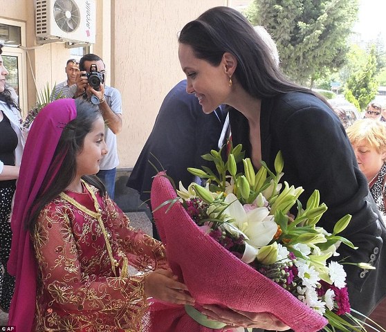 29CEFCBE00000578-0-Jolie_receives_flowers_as_she_is_welcomed_by_a_girl_on_arrival_a-a-11_1434904254416