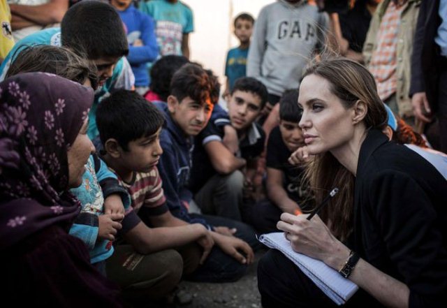 US actress Angelina Jolie (R) speaking with Syrian refugees in a Jordanian military camp based the the Jordan-Syria border on June 18, 2013. Pictured: Angelina Jolie Ref: SPL564347  200613   Picture by: UNHCR/LABAN-MATTEI/Splash News Splash News and Pictures Los Angeles:310-821-2666 New York:212-619-2666 London:870-934-2666 photodesk@splashnews.com 