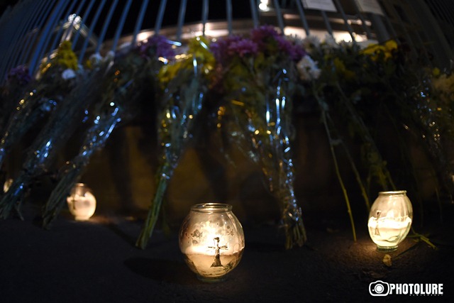 People put flowers in front of the French Embassy in Armenia in memory of the victims of terrorist attack in Paris, France