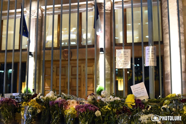 People put flowers in front of the French Embassy in Armenia in memory of the victims of terrorist attack in Paris, France
