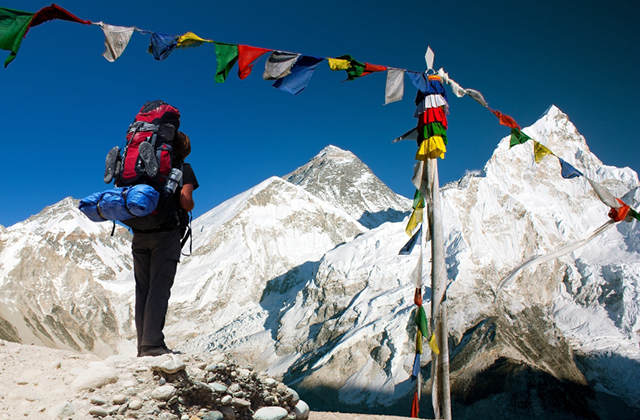 evening view of Everest with tourist and buddhist prayer flags from kala patthar and blue sky - way to Everest Base Camp - Nepal