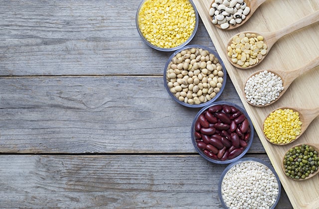 Group of beans on wood table background